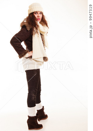 Winter fashion. Full length of curly girl woman in warm clothing Winter fashion. Full length of curly girl woman in warm clothing 9947319