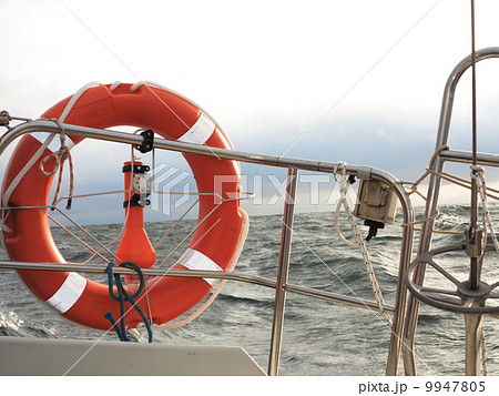 red lifebuoy on sail and stormy sky sea red lifebuoy on sail and stormy sky sea 9947805