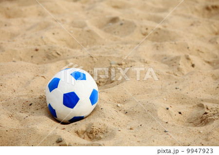 soccer ball on sandy beach background 9947923