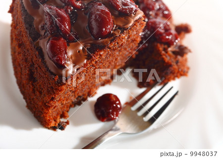 Piece of chocolate cake with icing and cherry Piece of chocolate cake with icing and cherry 9948037