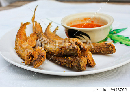 Fried small fish on the plate. 9948766