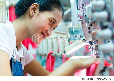 Indonesian Seamstress in Asian textile factory 9952515