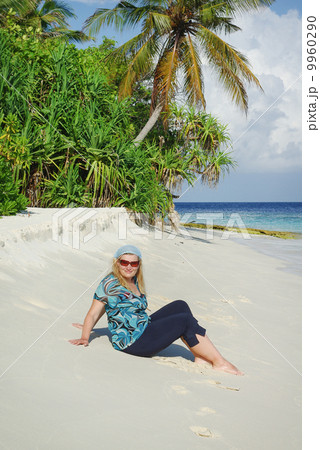 Young woman on white sand beach on Maldives Young woman on white sand beach on Maldives 9960290