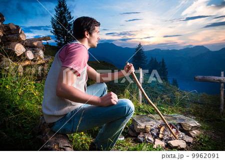 Alps - Man at campfire in Bavarian mountains 9962091