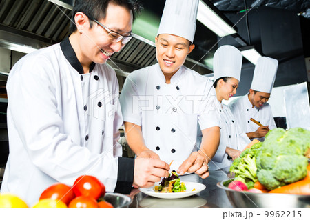 Asian Chef in restaurant kitchen cooking 9962215