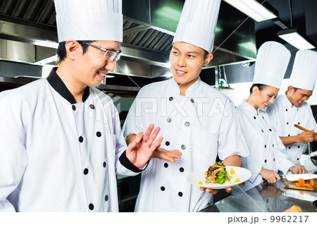 Asian Chef in restaurant kitchen cooking Asian Chef in restaurant kitchen cooking 9962217