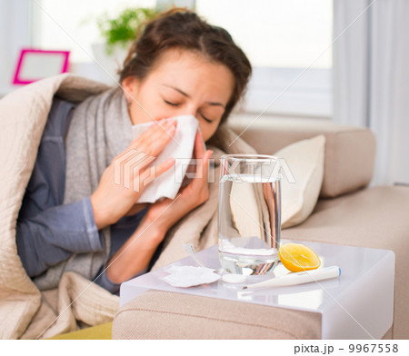 Sick Woman. Flu. Woman Caught Cold. Sneezing into Tissue 9967558