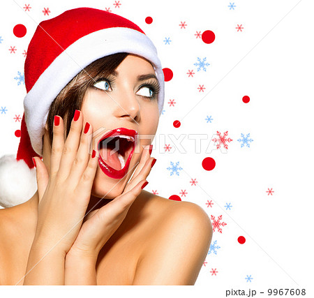 Christmas Woman. Beauty Model Girl in Santa Hat over White Christmas Woman. Beauty Model Girl in Santa Hat over White 9967608