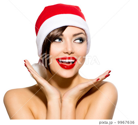 Christmas Woman. Beauty Model Girl in Santa Hat over White 9967636