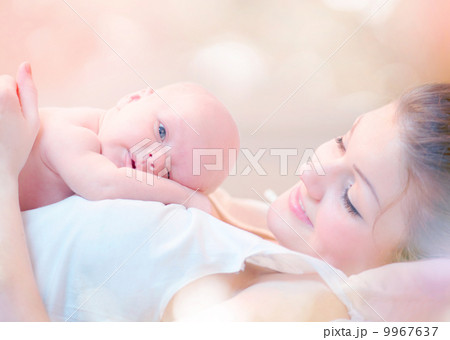 Happy Mother and her Newborn Baby Kissing and hugging 9967637