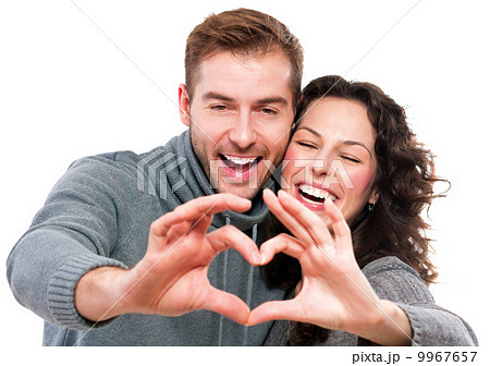 Valentine Couple Making Shape of Heart by their Hands 9967657
