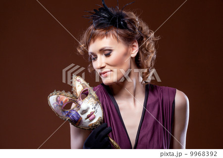 Actress posing with mask. Concept of Two-Face. Actress posing with mask. Concept of Two-Face. 9968392