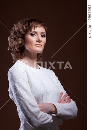 Beautiful middle-aged model posing in white blouse Beautiful middle-aged model posing in white blouse 9968393