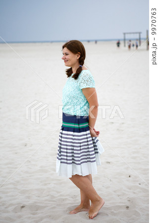 Young happy woman on the beach of St.Peter Ording, North Sea, 9970763