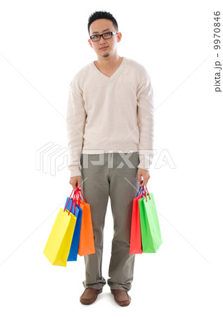 Bored Asian man holding shopping bags 9970846