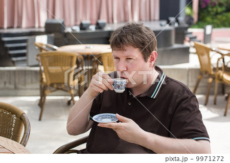 Young man drinking traditional turkish mocca coffee Young man drinking traditional turkish mocca coffee 9971272