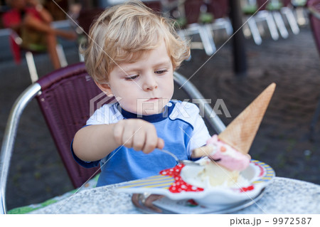 Little toddler boy eating ice cream in summer Little toddler boy eating ice cream in summer 9972587