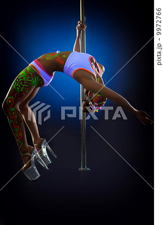 Seductive pole dancer exercising stretching Seductive pole dancer exercising stretching 9972766