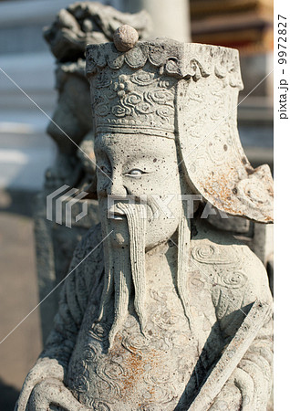 Statue of Chinese stone guardian at Wat Pho Temple. Thailand 9972827
