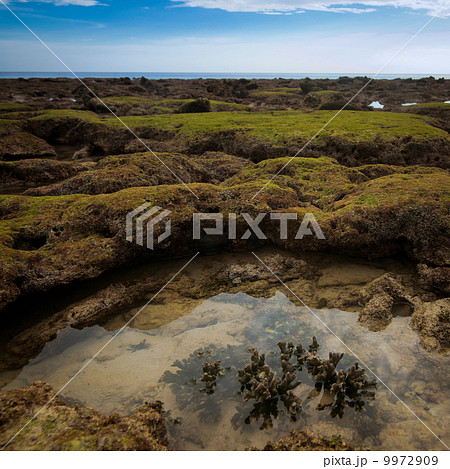 Sunset at tropical beach with rocks and stones 9972909
