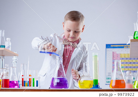 Inquisitive naturalist mixes reagents in flask Inquisitive naturalist mixes reagents in flask 9973922