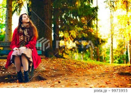 Young elegant woman sitting on bench Young elegant woman sitting on bench 9973955