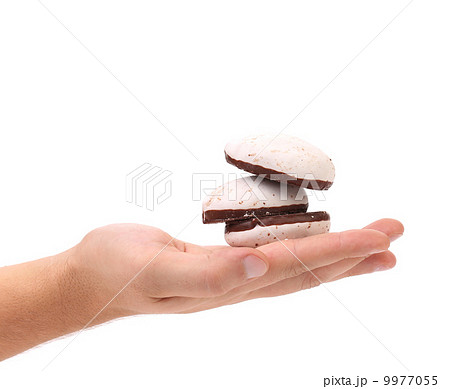 White Kiss Cookies with chocolate in hand. White Kiss Cookies with chocolate in hand. 9977055