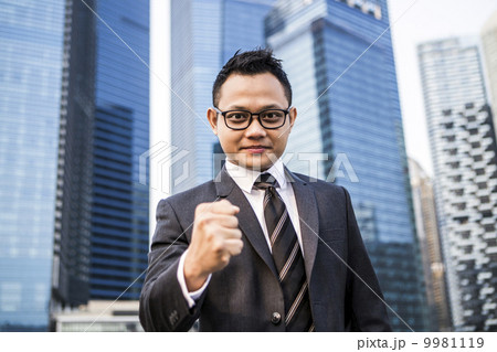 Young male malay executive giving a fist pump 9981119