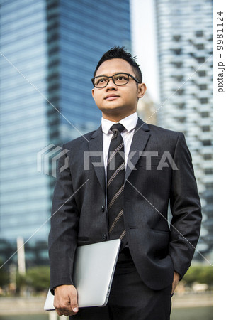 Young male malay executive with laptop 9981124