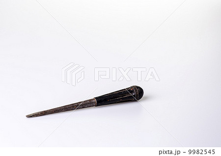 Old black screwdriver on white background 9982545