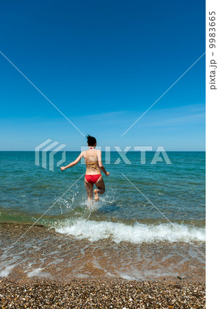 Girl running into the Sea 9983665