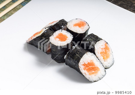Makisushi on white plate. Seafood traditional maki sushi rolls with chopsticks Makisushi on white plate. Seafood traditional maki sushi rolls with chopsticks 9985410