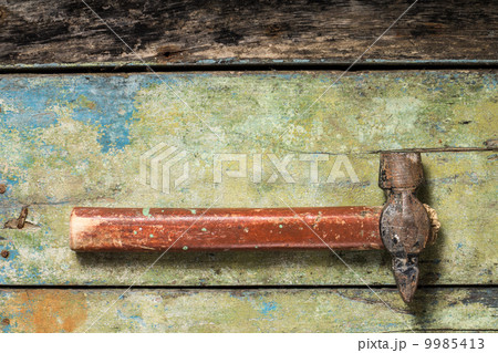 Old rustic hammer on wood background 9985413