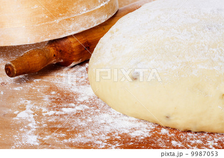 dough with rolling pin on floured table top view dough with rolling pin on floured table top view 9987053