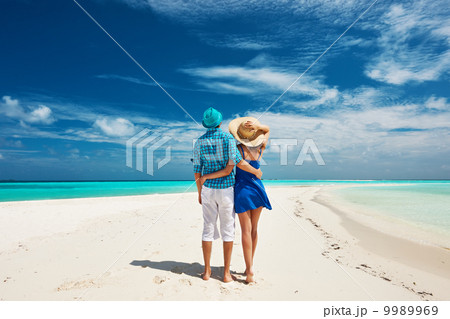 Couple in blue on a beach at Maldives 9989969