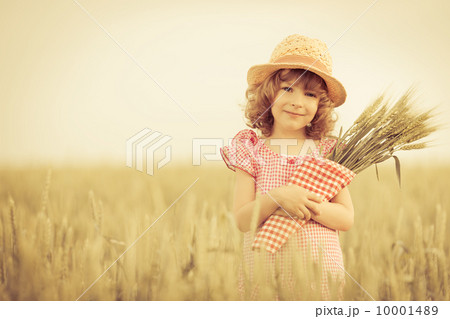 Happy child holding wheat 10001489