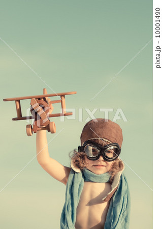 Happy kid playing with toy airplane 10001490