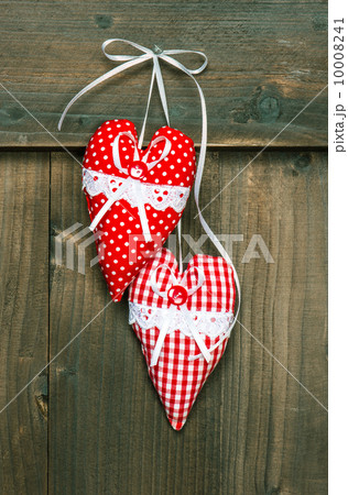 red hearts hanging over wooden background red hearts hanging over wooden background 10008241