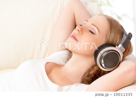 beautiful girl in headphones enjoying music at home beautiful girl in headphones enjoying music at home 10011335