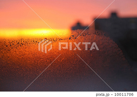 Background with ice, morning sunlight and silhouettes of houses Background with ice, morning sunlight and silhouettes of houses 10011706