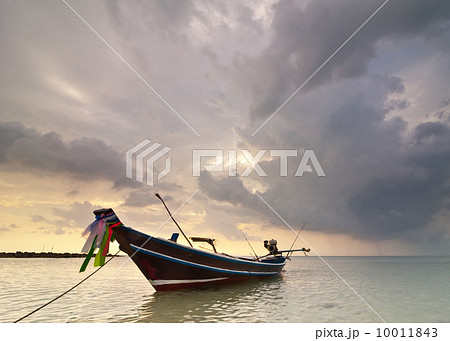 Sunset at tropical beach with Thai fishing boat Sunset at tropical beach with Thai fishing boat 10011843