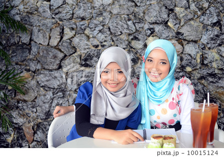 Young asian muslim woman in head scarf Young asian muslim woman in head scarf 10015124