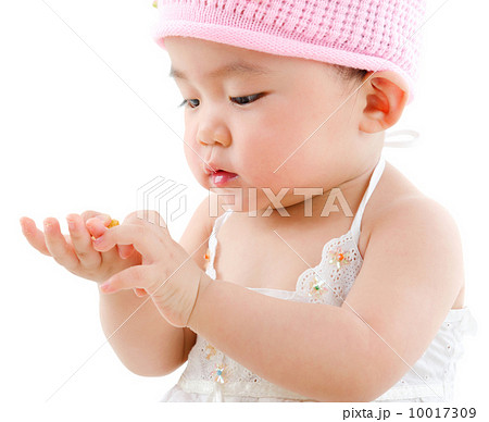 Asian baby girl eating snack 10017309