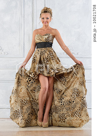 Beautiful bonde woman in leopard patterned  long dress. 10021708