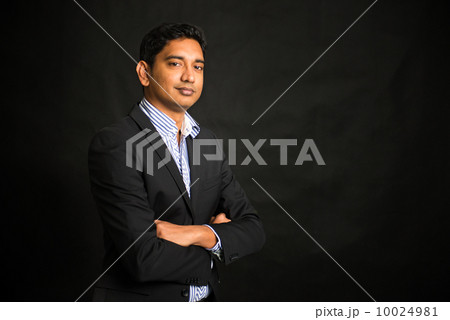indian business man on dark background, crossed arm indian business man on dark background, crossed arm 10024981