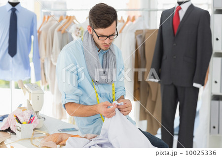 Concentrated male fashion designer at work Concentrated male fashion designer at work 10025336
