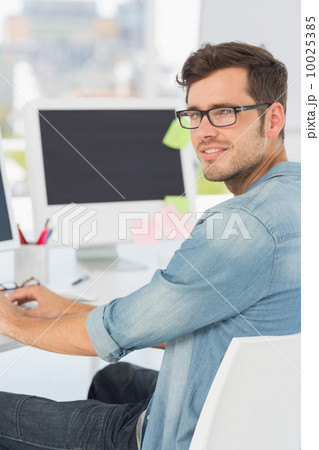 Side view portrait of a male artist using computer 10025385
