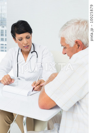 Female doctor explaining reports to senior patient 10025879