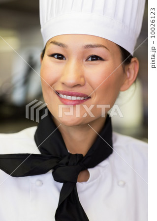 Closeup of a female cook in kitchen Closeup of a female cook in kitchen 10026123