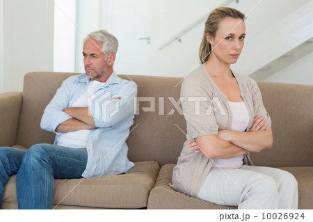 Angry couple sitting on couch not talking to each other 10026924